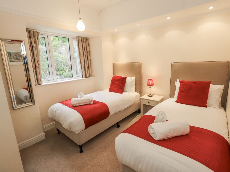 A bedroom with two beds and a window at Miyanli in Bowness
