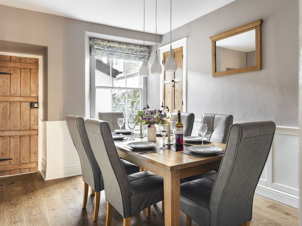 A dining room with a table and chairs at Herdwick Cottage Ambleside