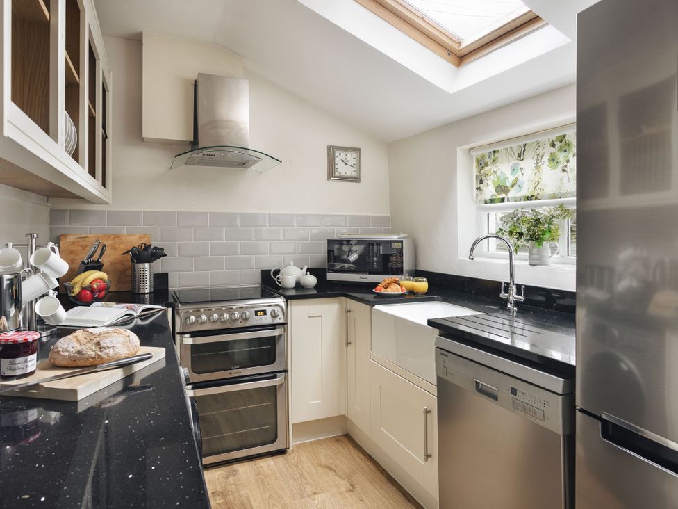 A kitchen with appliances and countertop at Herdwick Cottage Ambleside
