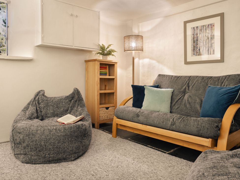 A snug with a sofa and bean bag chair at Herdwick Cottage Ambleside