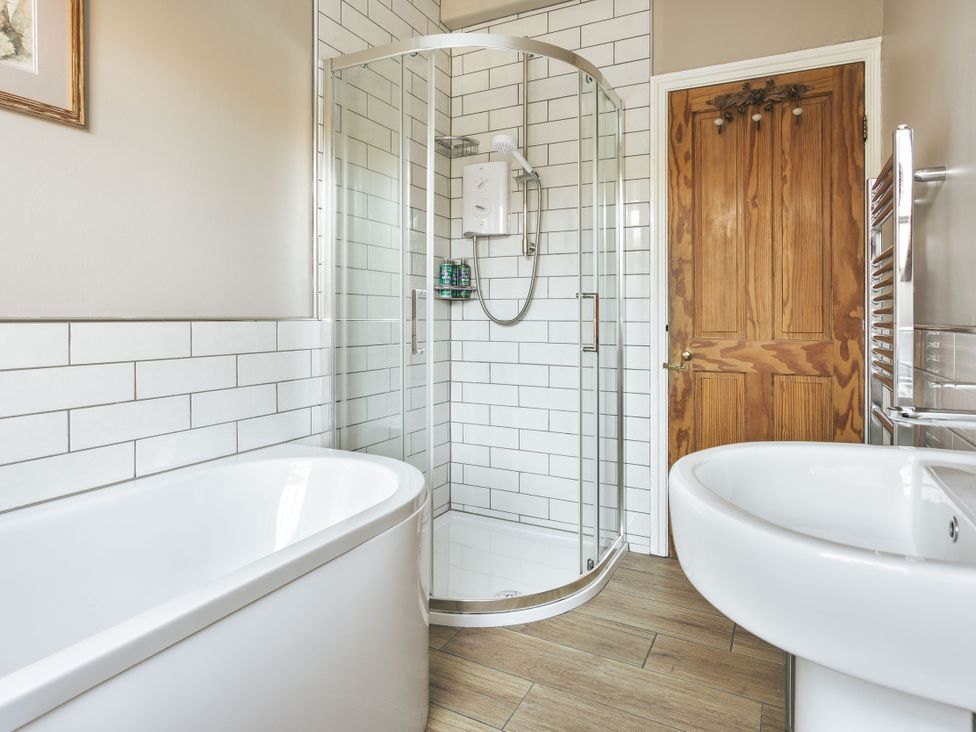 A bathroom with a shower, bathtub, and sink at Herdwick Cottage Ambleside in Ambleside