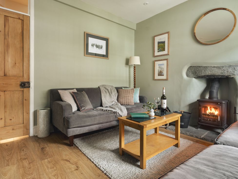 A living room with a sofa and coffee table at Herdwick Cottage Ambleside in Ambleside