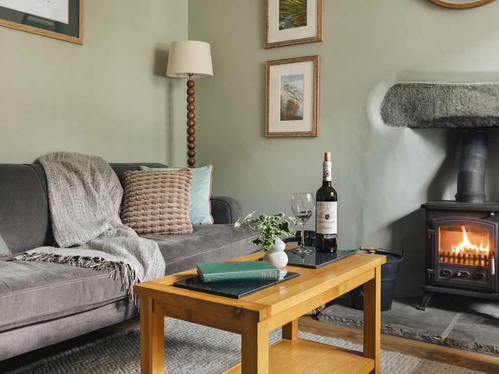 A living room with a sofa and a coffee table at Herdwick Cottage Ambleside