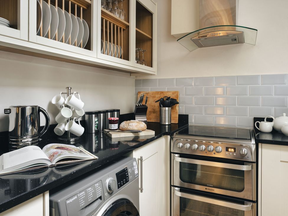 A kitchen with appliances and utensils at Herdwick Cottage Ambleside