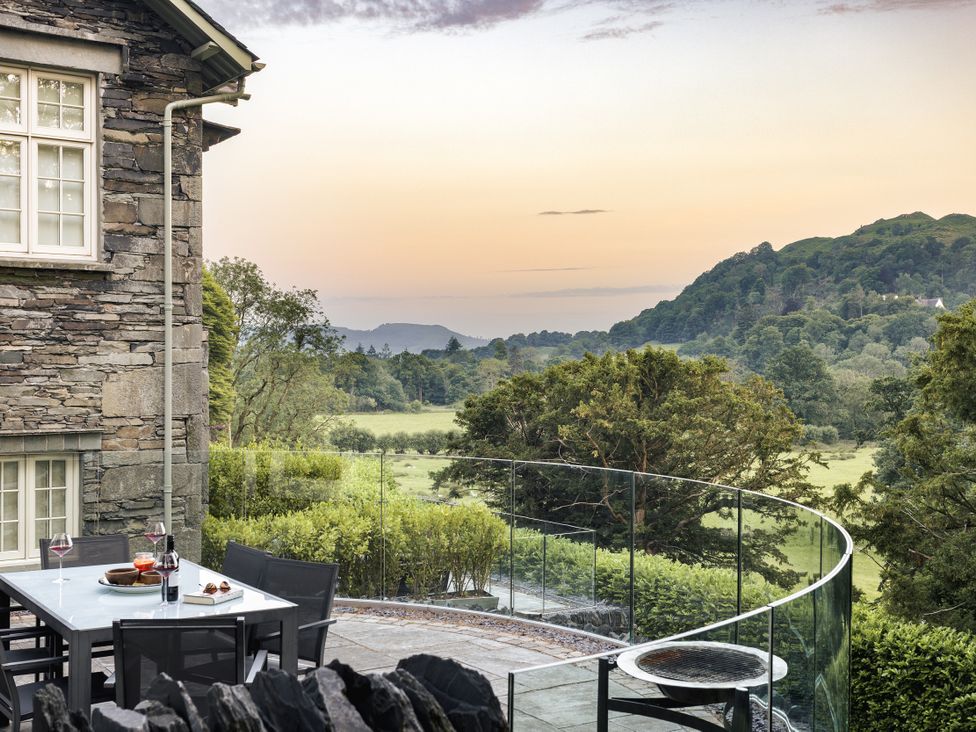 An outdoor dining area with a view of hills at Take Five in Ambleside