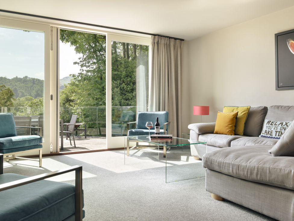 A living room with a sofa and armchairs at Take Five in Ambleside