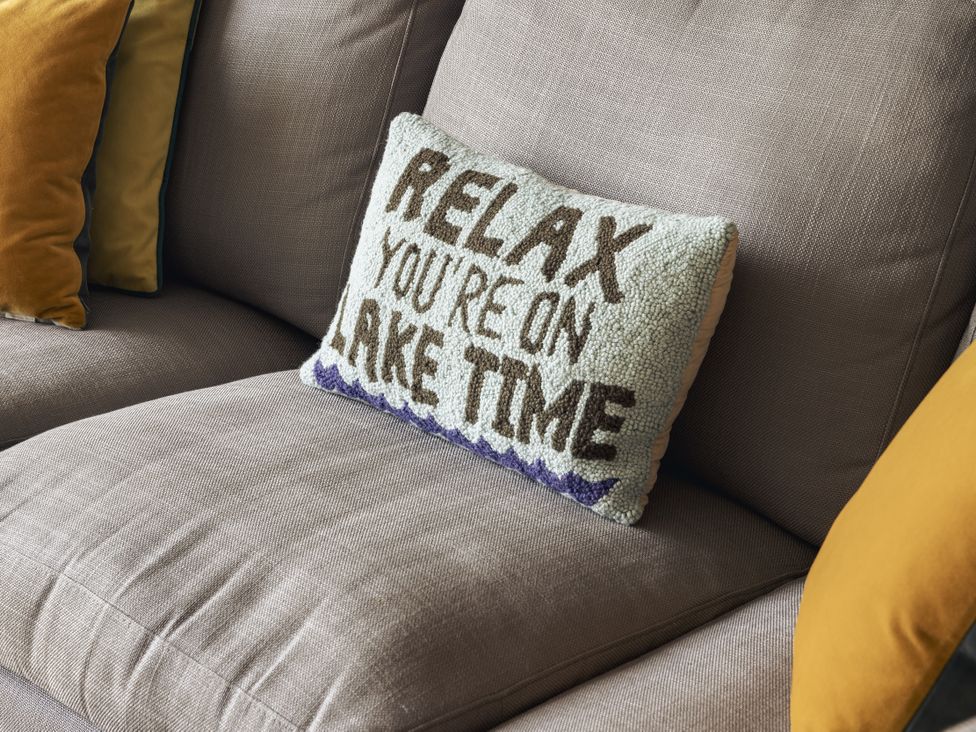 A sofa with decorative pillows at Take Five in Ambleside