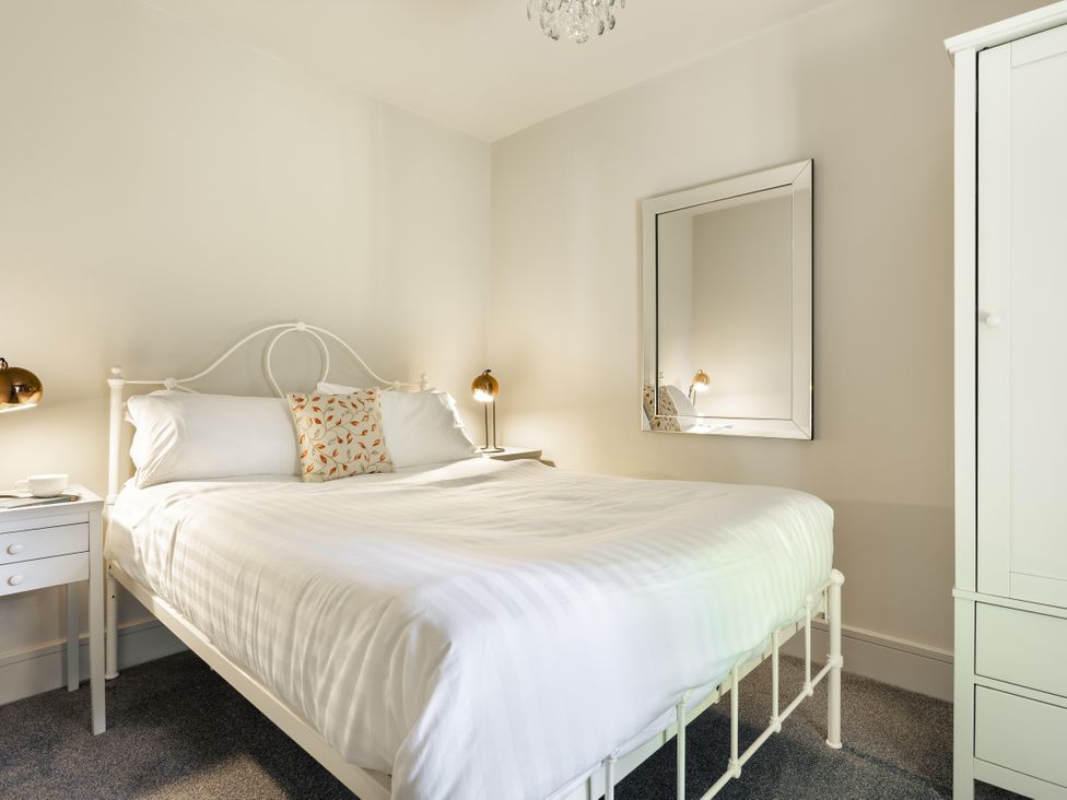A bedroom with a bed and nightstand at Take Five in Ambleside