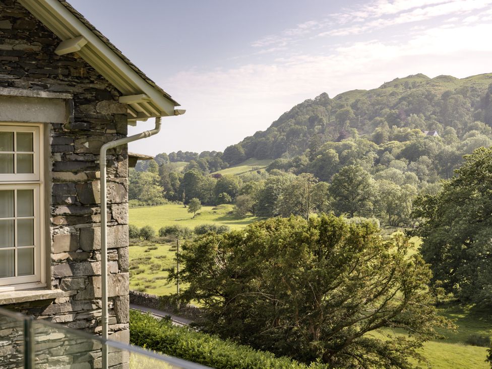 A view of trees and grass from the window at Take Five in Ambleside