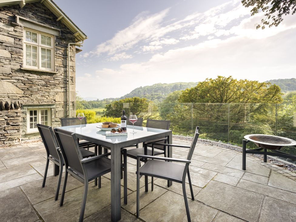 An outdoor seating area with a table and chairs at Take Five in Ambleside