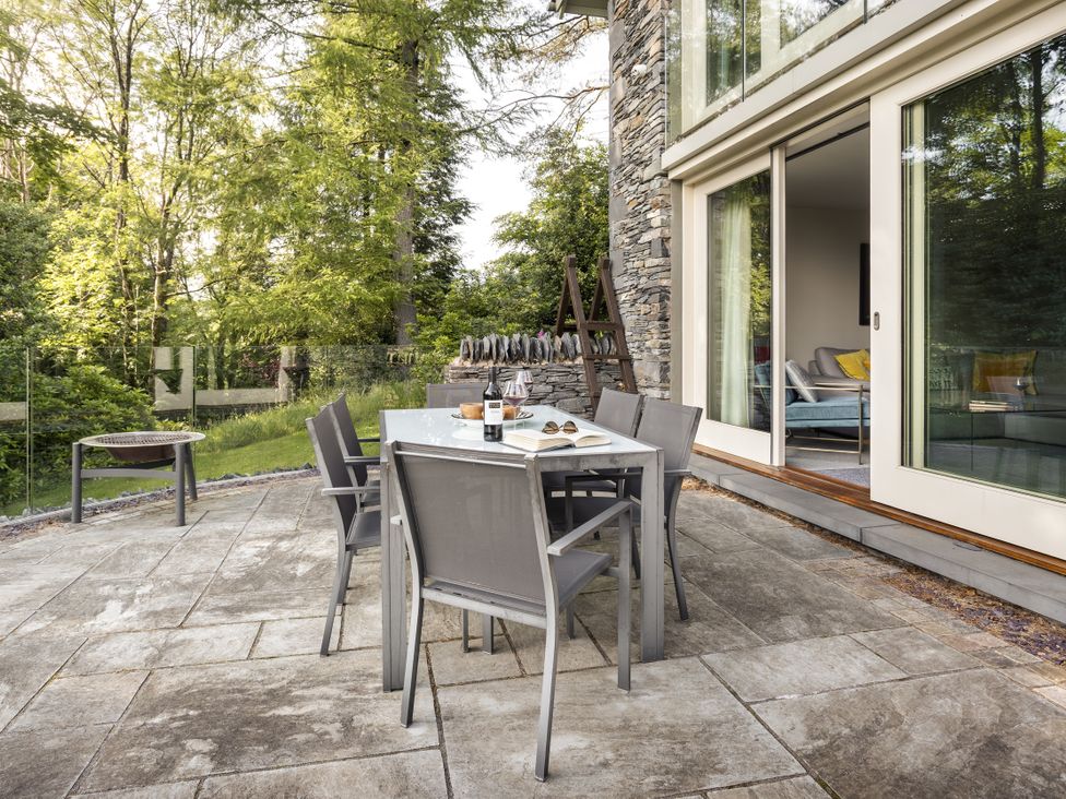 An outdoor dining area with a table and chairs at Take Five in Ambleside
