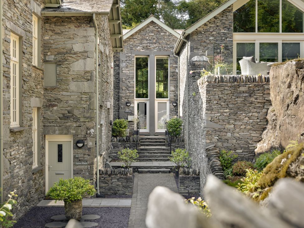 An outdoor space with stone walls and a pathway at Take Five in Ambleside