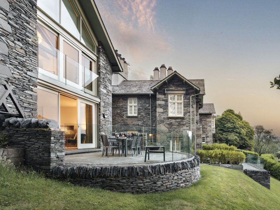 A patio area with a table and chairs at Take Five in Ambleside