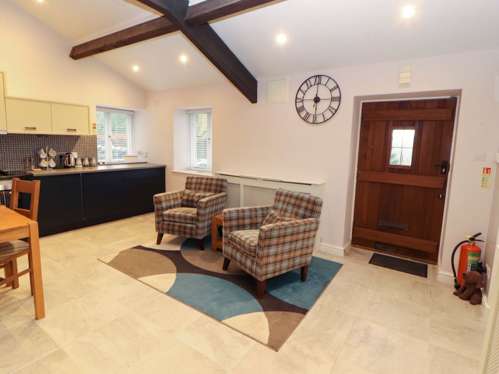A kitchen with chairs and a table at Cragfell Cottage in Cartmel Fell