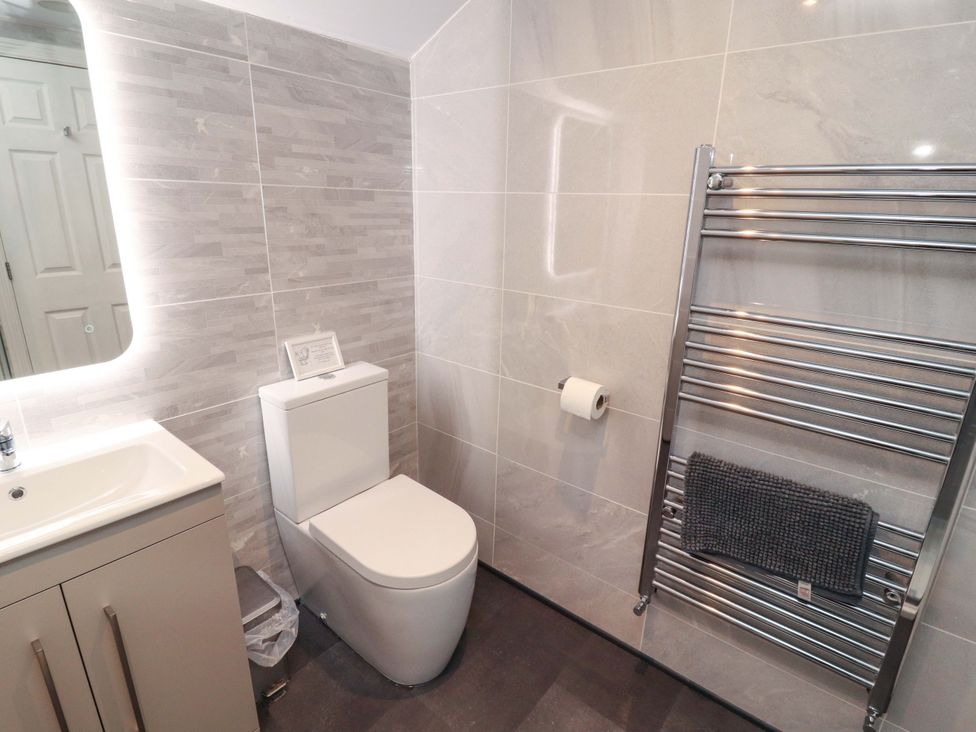A bathroom with a toilet and sink at Cragfell Cottage in Cartmel Fell
