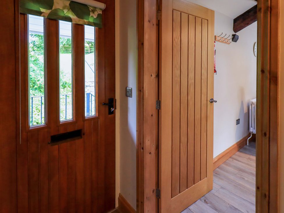 A hallway with a front door and interior door at Abbots Reading Mews 2 Grizedale