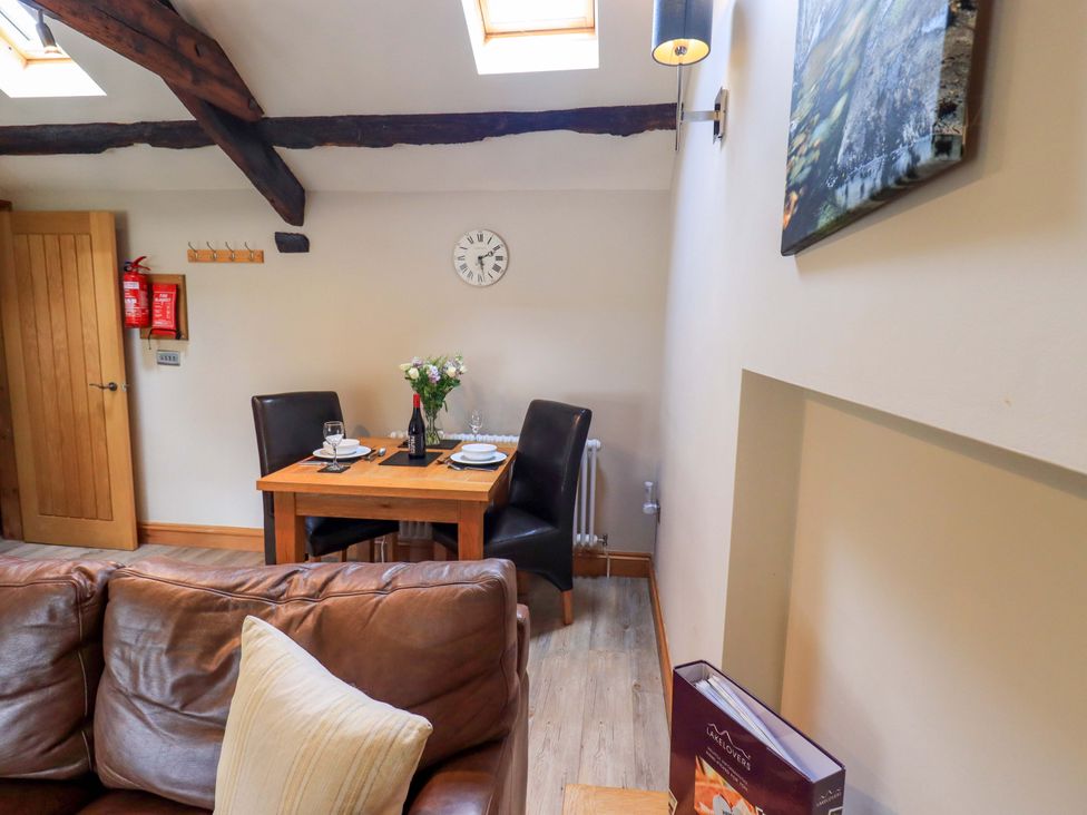 A dining area with a table and chairs at Abbots Reading Mews 2 in Grizedale