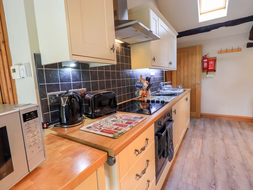A kitchen with appliances and wooden cabinetry at Abbots Reading Mews 2 in Grizedale