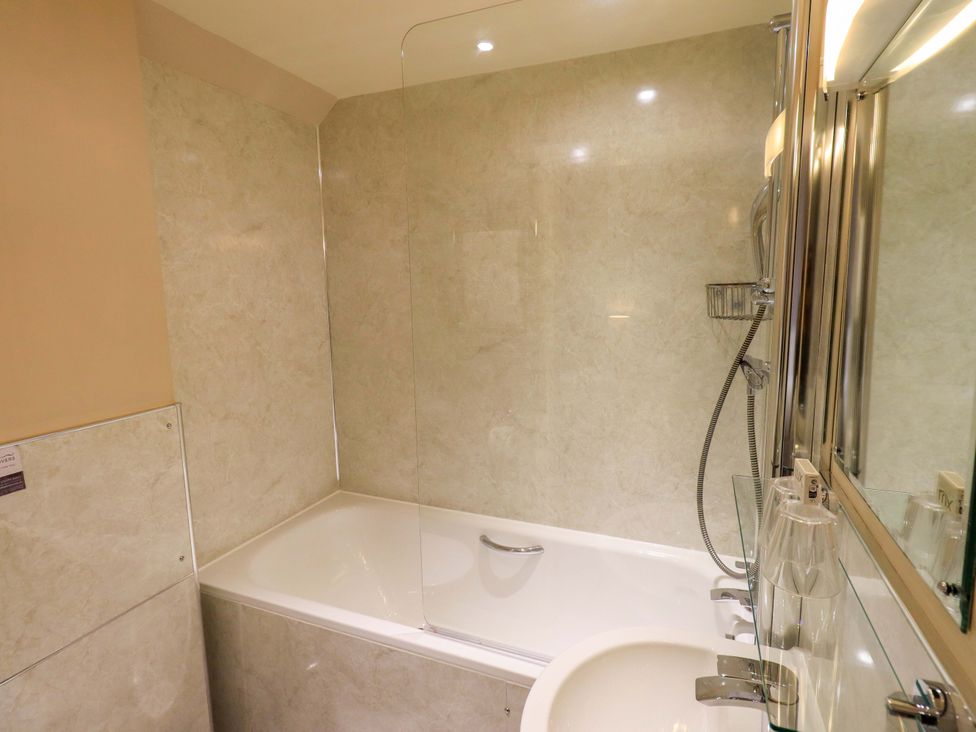 A bathroom with a bathtub and shower at Abbots Reading Mews 2 Grizedale