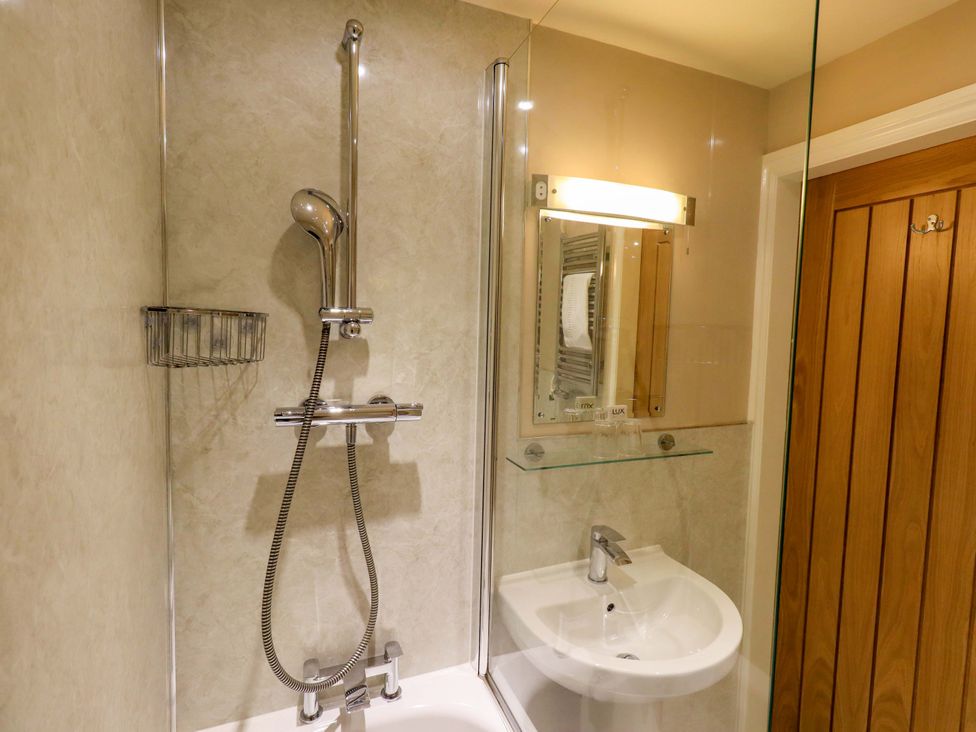 A bathroom with a shower and sink at Abbots Reading Mews 2 Grizedale