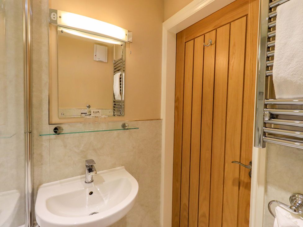 A bathroom with a sink and mirror at Abbots Reading Mews 2 in Grizedale