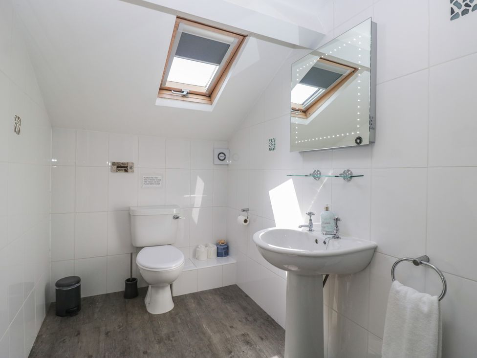 A bathroom with toilet and sink at Woodside West in Bowness