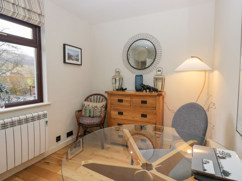 A dining room with a table and chairs at Corner Cottage in Troutbeck