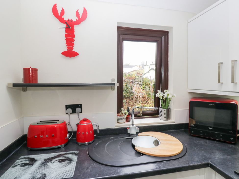 A kitchen with a red toaster and kettle at Corner Cottage in Troutbeck
