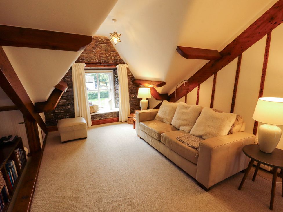 A snug with a sofa and a lamp at High Raise in Grasmere