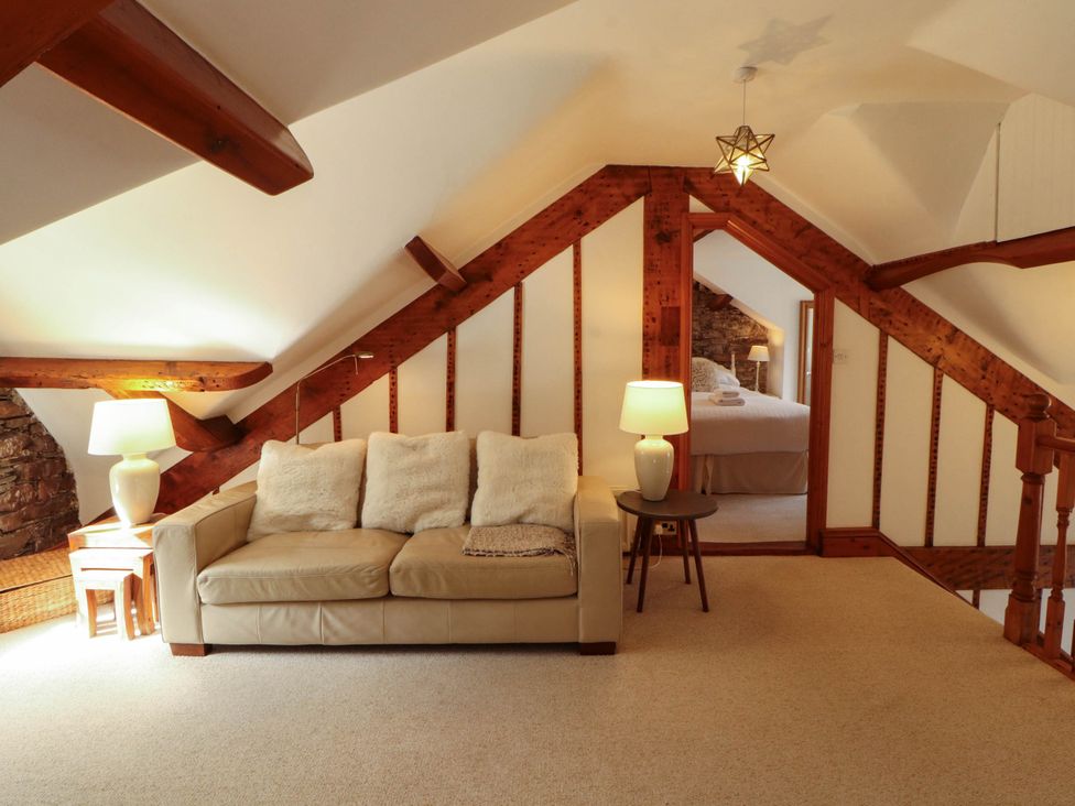 A living room with a sofa and lamps at High Raise in Grasmere