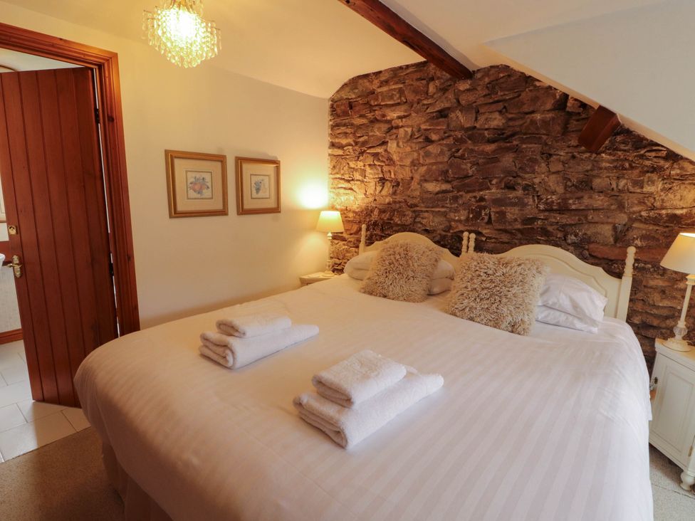 A bedroom with a bed and bedside tables at High Raise in Grasmere
