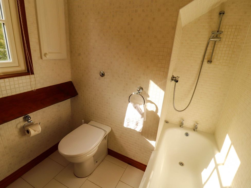 A bathroom with a toilet and bathtub at High Raise in Grasmere