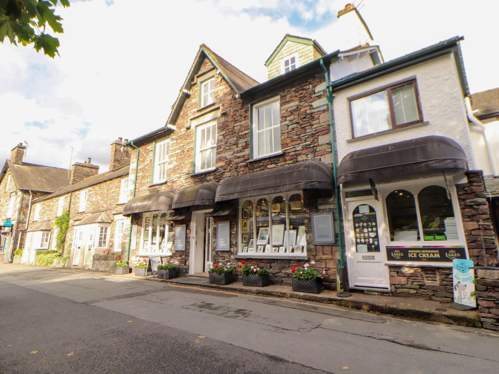 A building with shops and planters on a street at High Raise in Grasmere