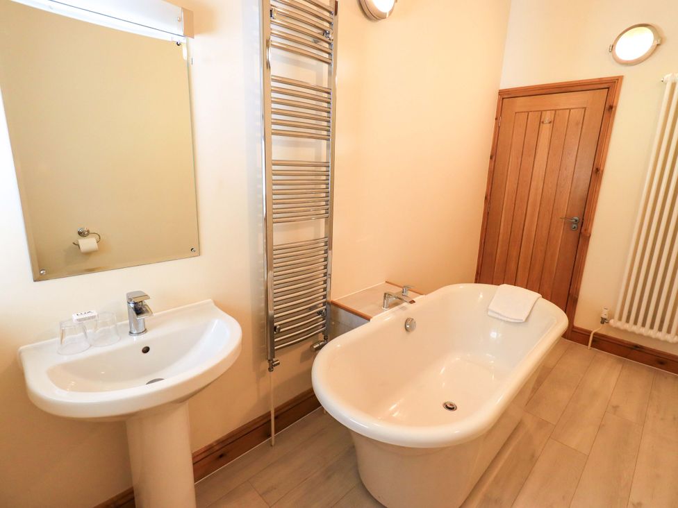 A bathroom with a sink and bathtub at Abbots Reading Cottage in Lakeside