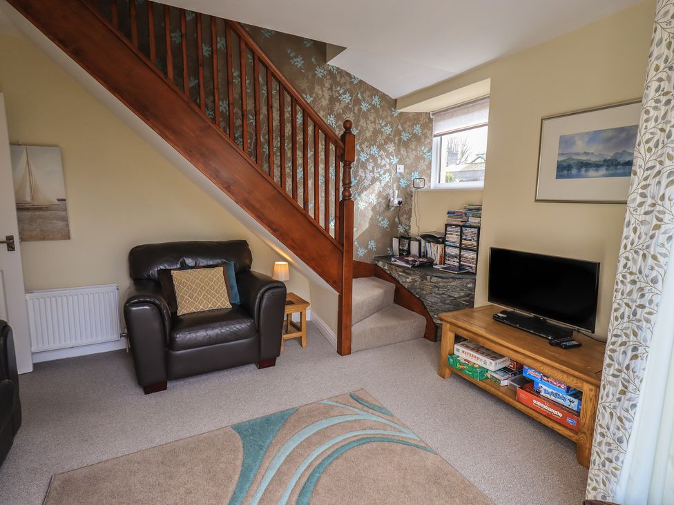 A living room with a sofa and television at A River Runs By in Staveley