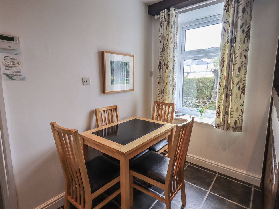 A dining room with a table and chairs at A River Runs By in Staveley