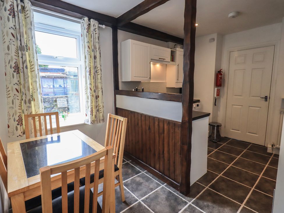 A kitchen with a table and chairs at A River Runs By in Staveley