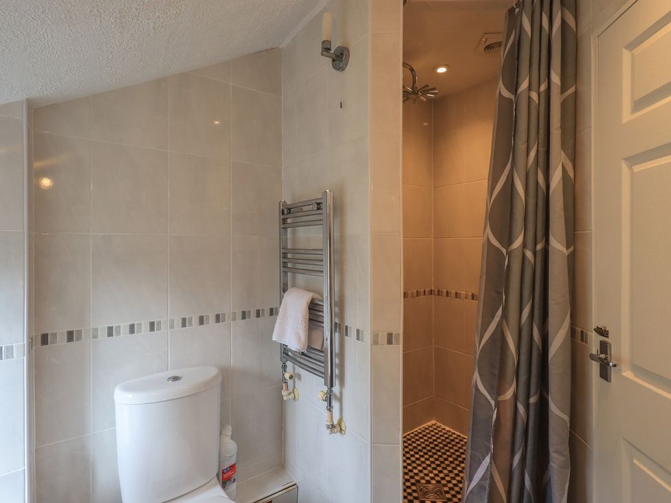 A bathroom with a shower and toilet at A River Runs By in Staveley