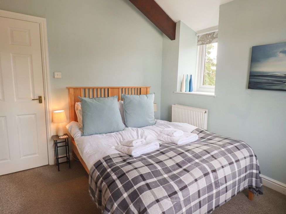 A bedroom with a bed and pillows at A River Runs By in Staveley