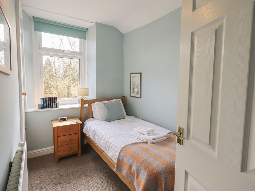 A bedroom with a bed and bedside table at A River Runs By in Staveley