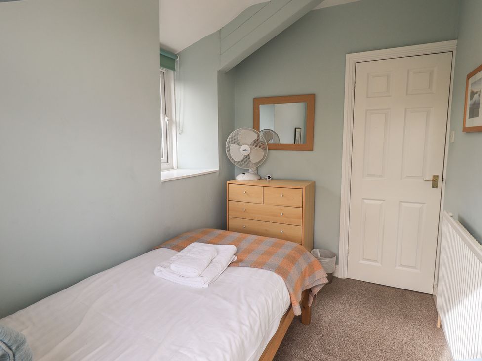 A bedroom with a bed and dresser at A River Runs By Staveley