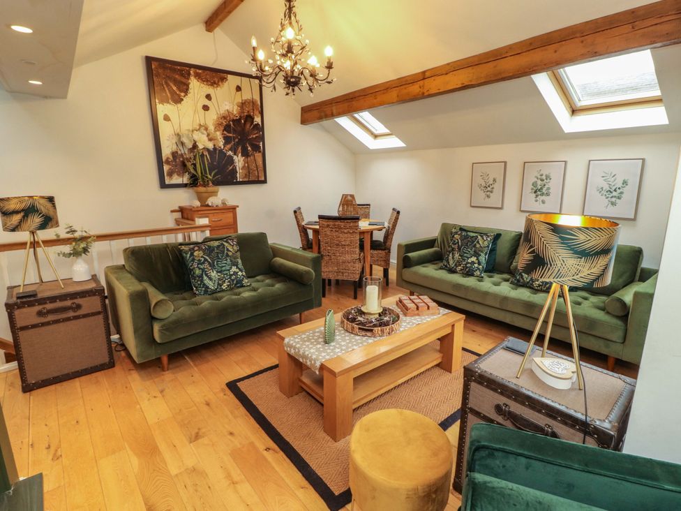 A living room with sofas and a coffee table at Workshop Cottage in Bowness