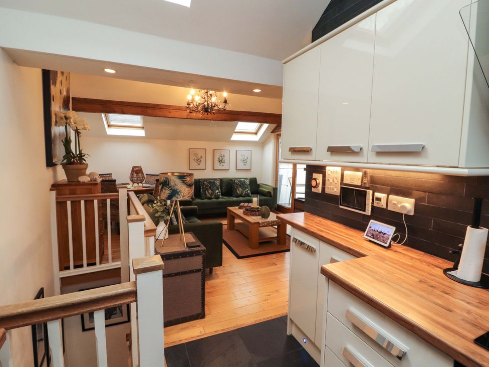 A kitchen leading to a living room at Workshop Cottage in Bowness