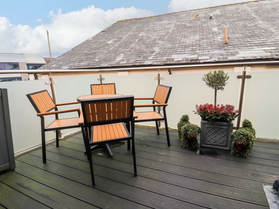 A balcony with a table and chairs at Workshop Cottage in Bowness