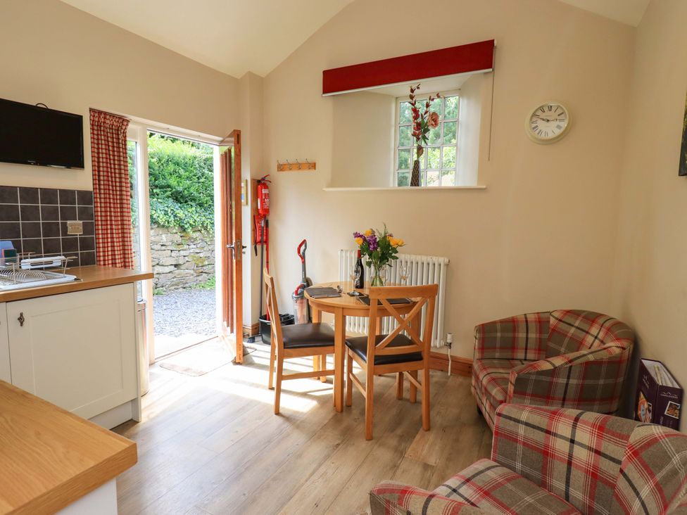 A kitchen with table and chairs at Abbots Reading Suite in Lakeside