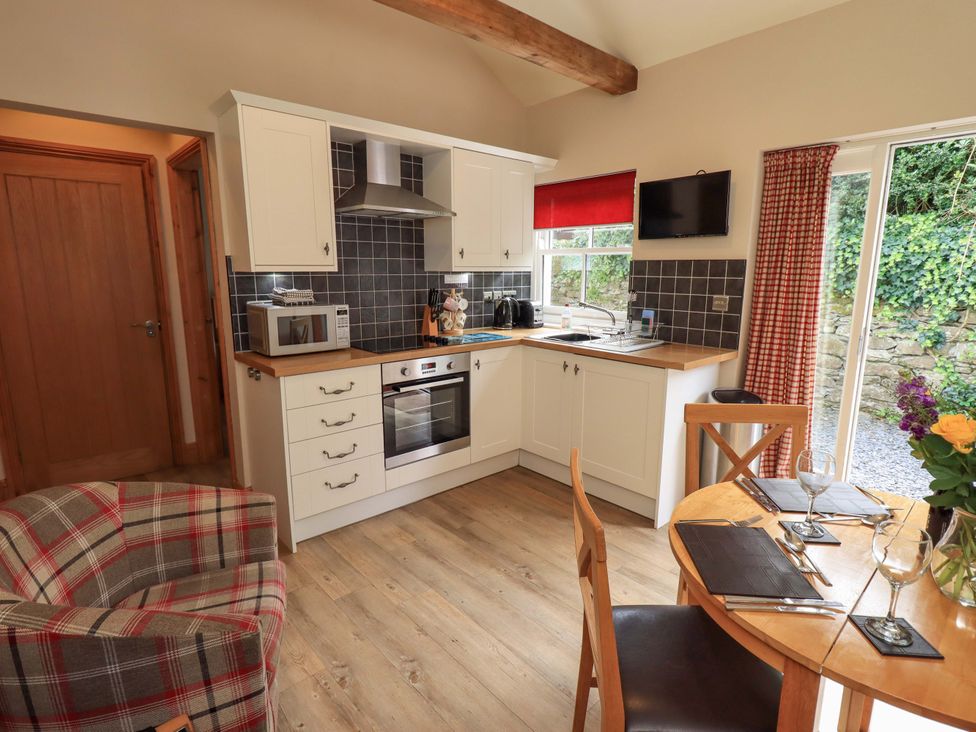 A kitchen with a dining table and chairs at Abbots Reading Suite in Lakeside