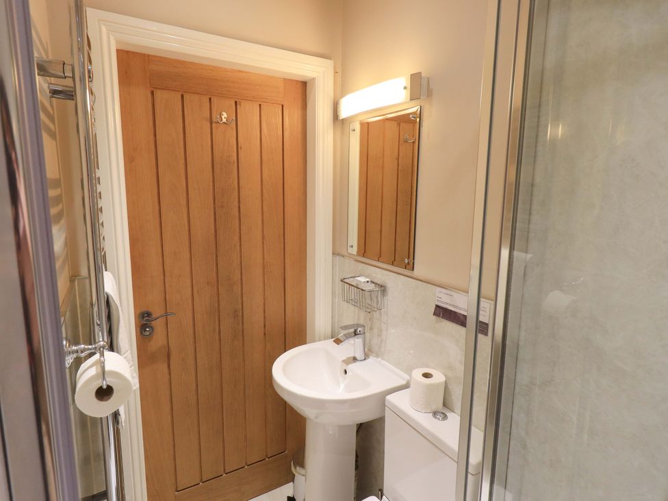 A bathroom with a sink and toilet at Abbots Reading Suite in Lakeside