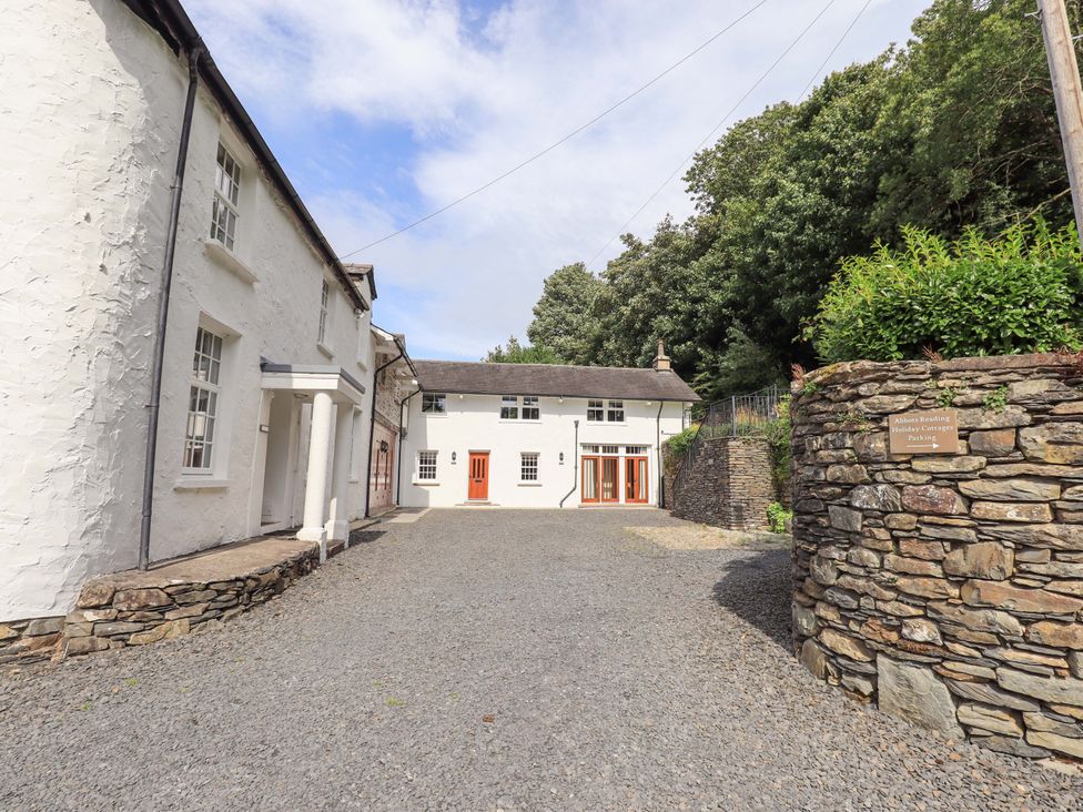 An outdoor area with buildings and a gravel driveway at Abbots Reading Suite in Lakeside