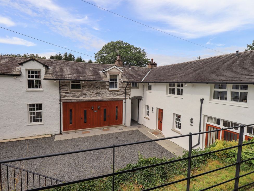 An outdoor view of a building with a gravel driveway at Abbots Reading Suite, Lakeside