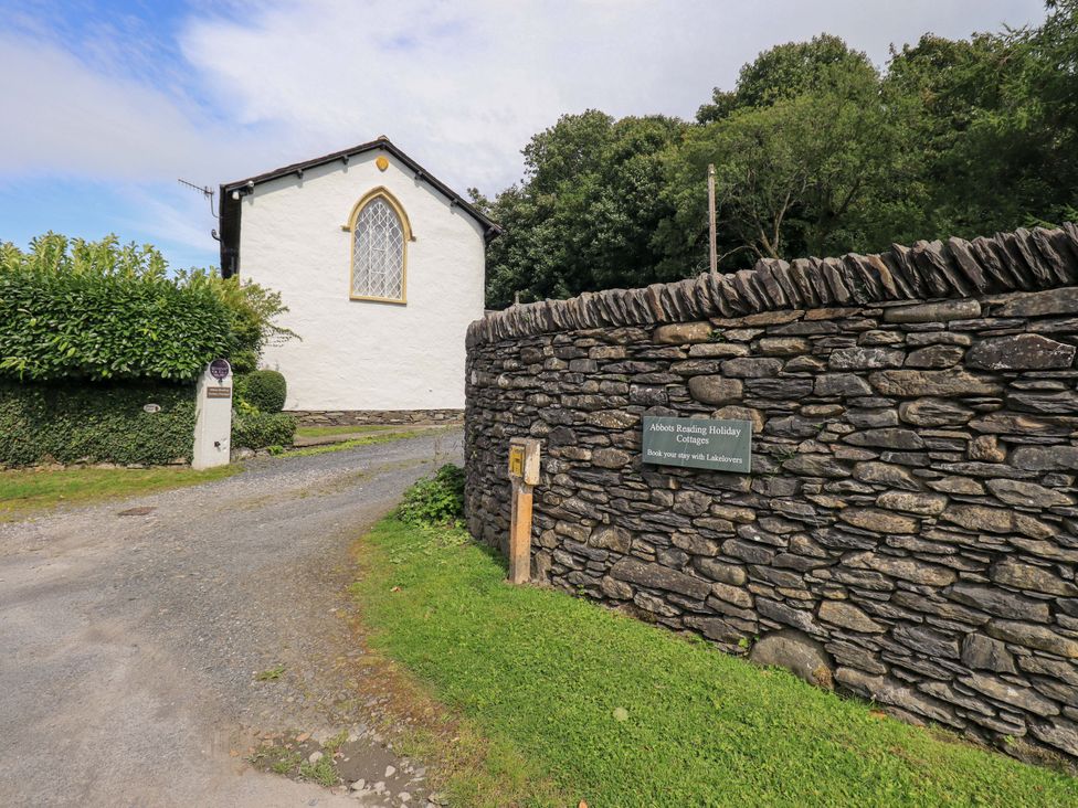 An outdoor view of a building and stone wall at Abbots Reading Suite Lakeside